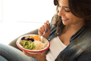 Woman Chewing Slowly and Eating Vegan Meal for Weight Loss